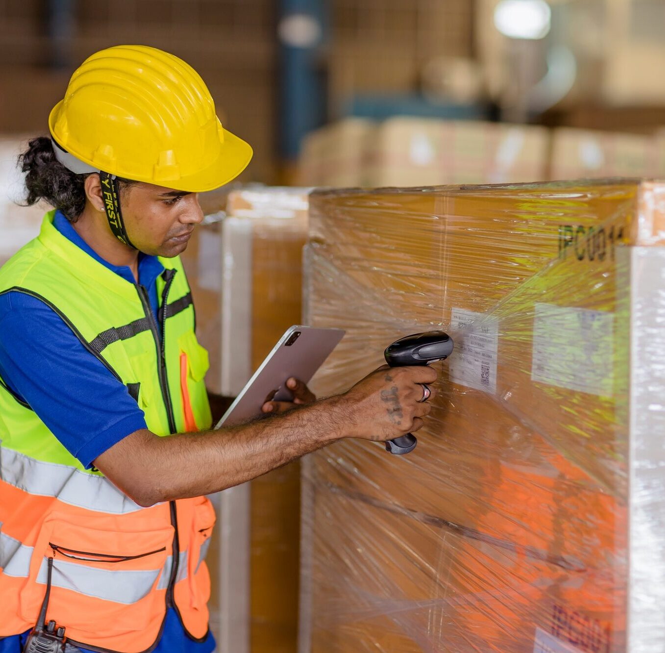 indian worker in logistics industry working inventory management system using barcode reader